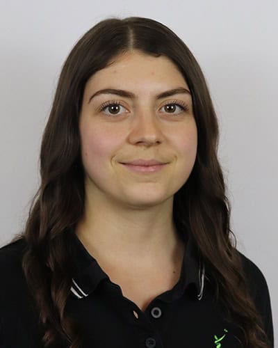 Portrait of a young woman with long brown hair and a friendly smile.