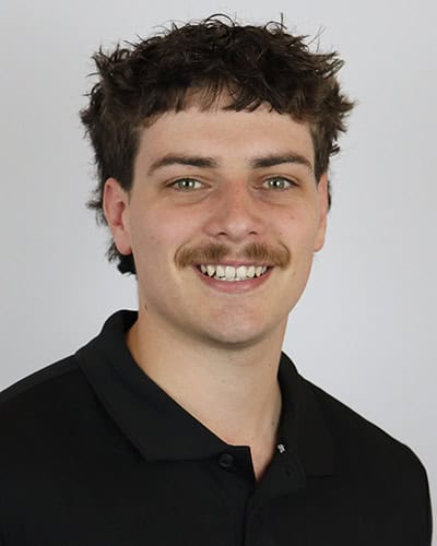 Male physio therapist with brown hair and black polo shirt at Core Physio & Pilates.