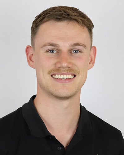 Experienced physio male smiling at Core Physio & Pilates clinic in Australia.