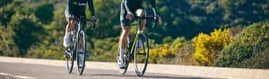 Cyclists riding on a scenic road for physiotherapy and rehabilitation in Australia.